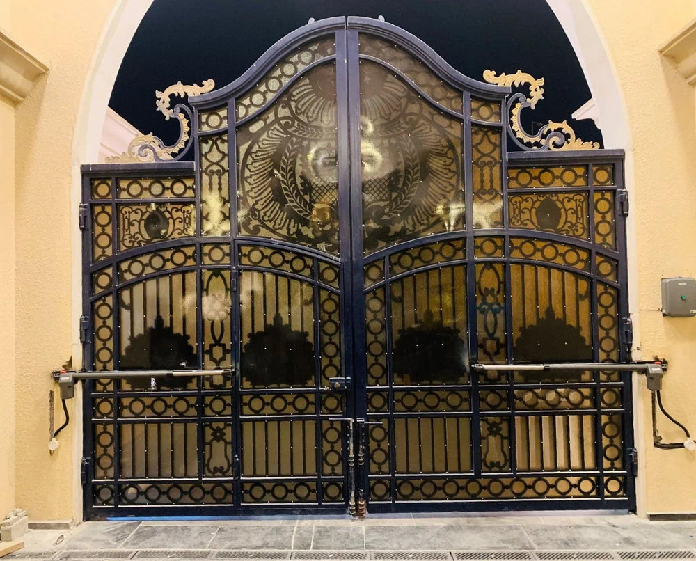 Luxury ornate swing gate with automated system, featuring intricate metalwork and gold accents for Qatari homes.