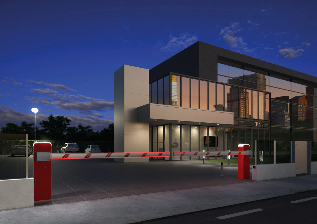 Red automatic barrier gate at modern building entrance, dusk scene with security lighting, Italian-made gate automation