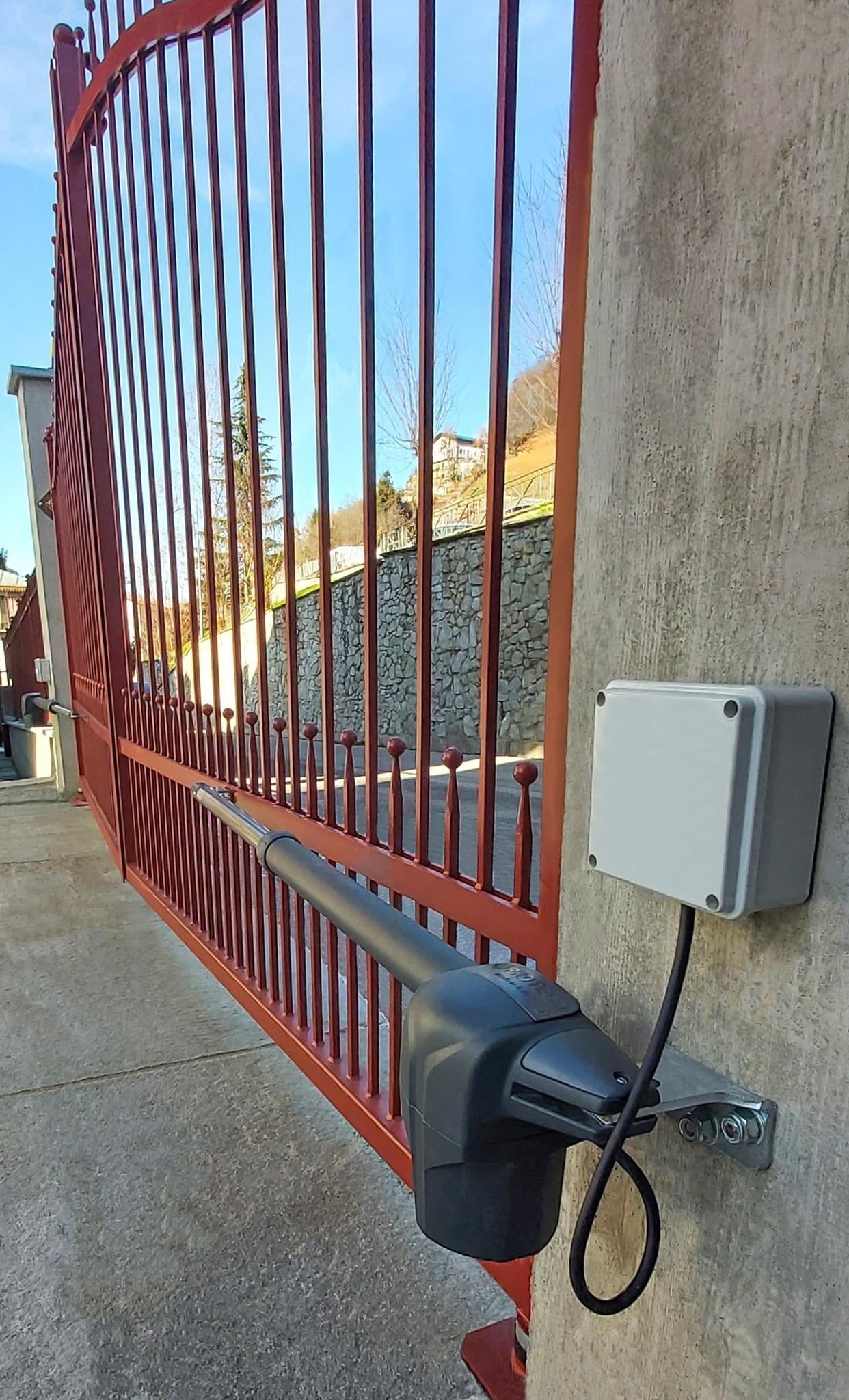 ProtecoAster-4 230V heavy duty swing gate motor installed on a red gate.